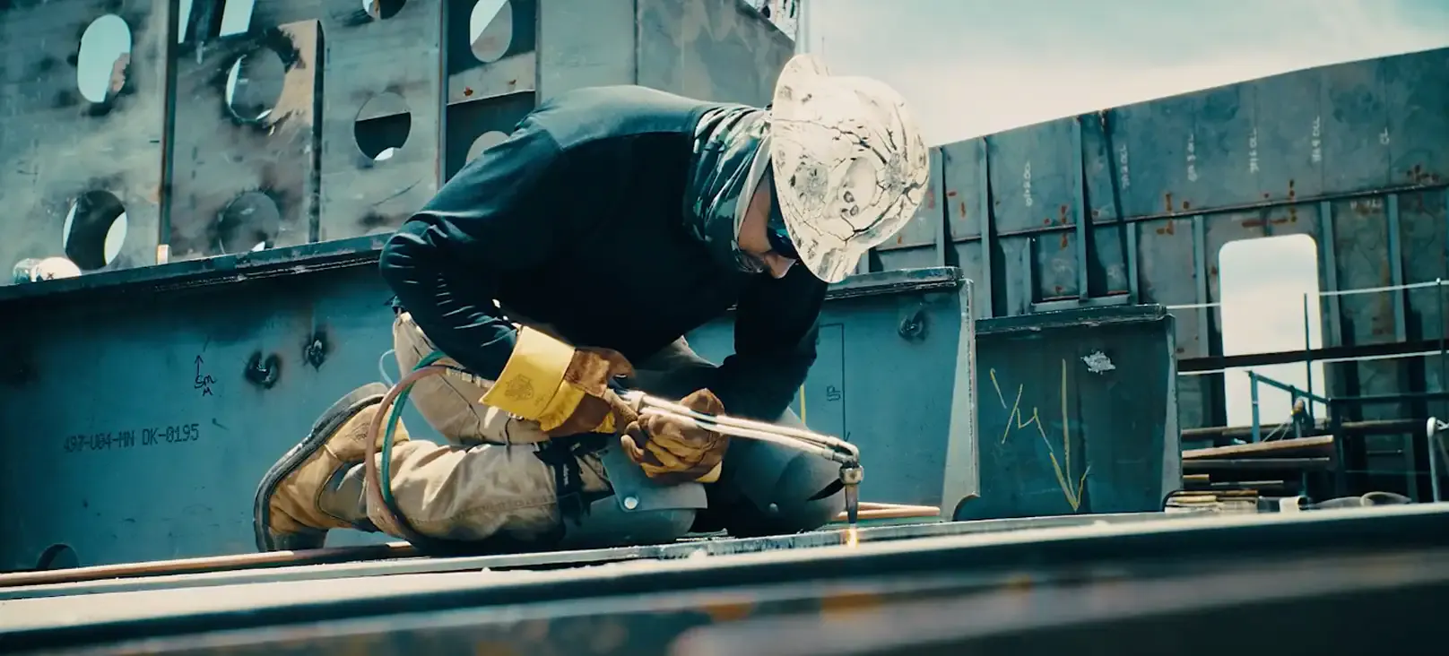AEU brand film by nez&pez featuring a shipyard worker cutting steel, part of a cinematic brand storytelling project highlighting the insurer's maritime roots and connection to the longshore industry.