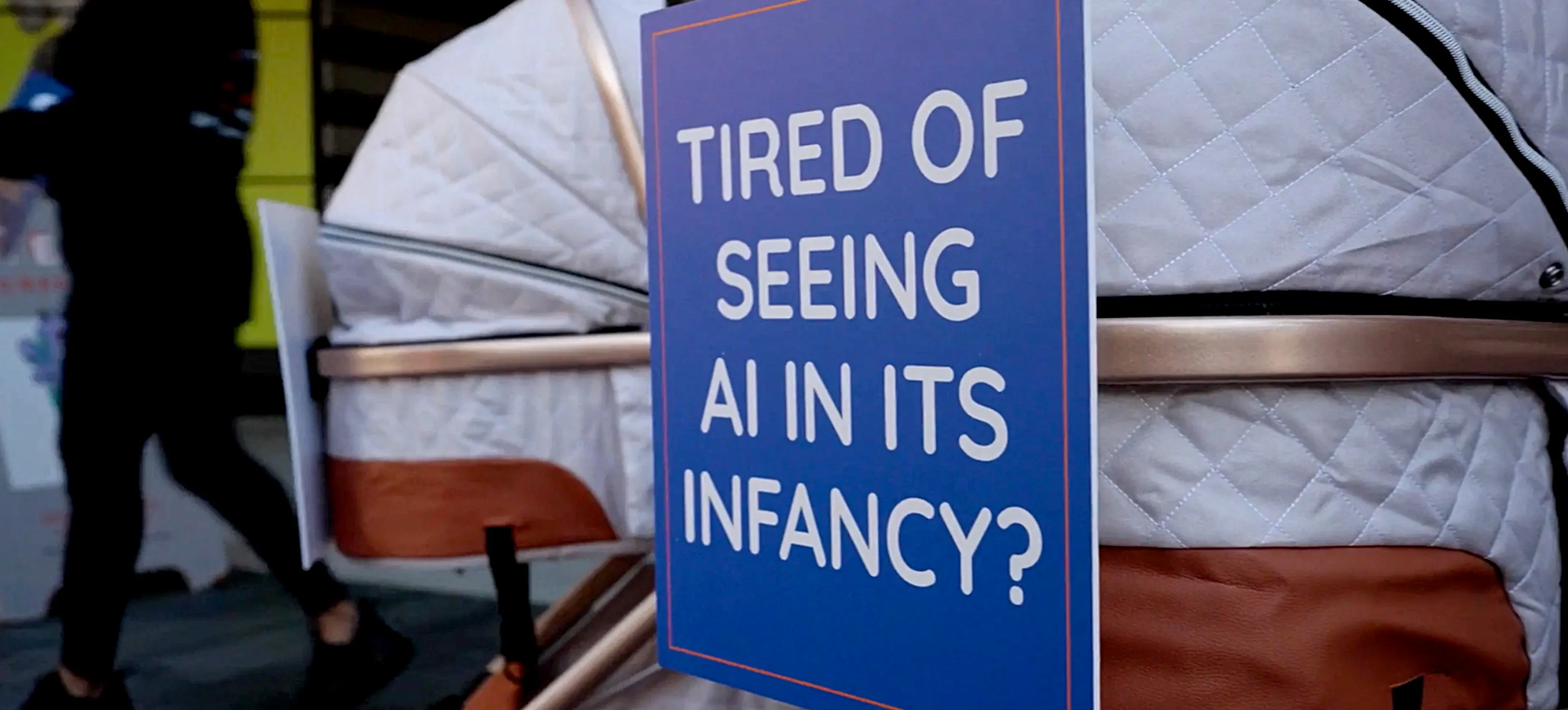 Stellar Cyber's RSAC 2026 guerrilla marketing activation featuring a baby stroller with a sign reading “Tired of seeing AI in its infancy?”